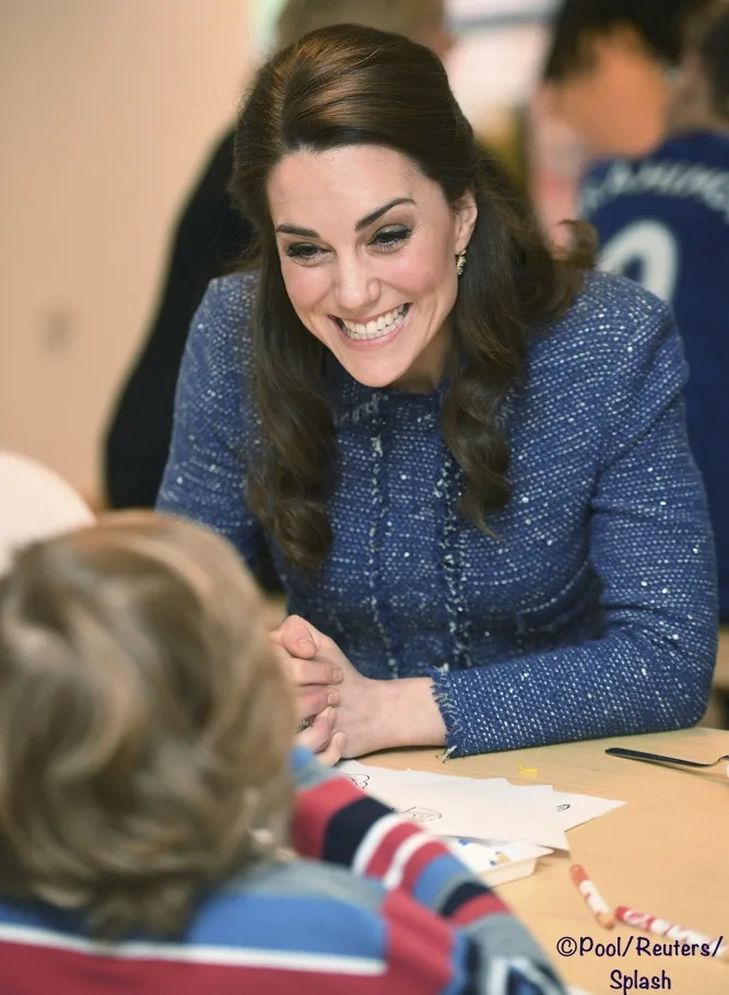 Britain's Catherine the Duchess of Cambridge speaks to a child at the Ronald Mc Donald House, the accommodation for families of children being treated at Evelina's children's hospital in London